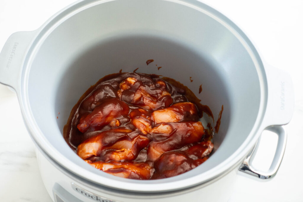 bbq sauce on thighs in the slow cooker