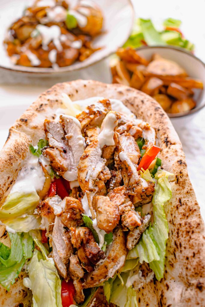 chicken shawarma in the ninja dual air fryer with a naan bread and sauce