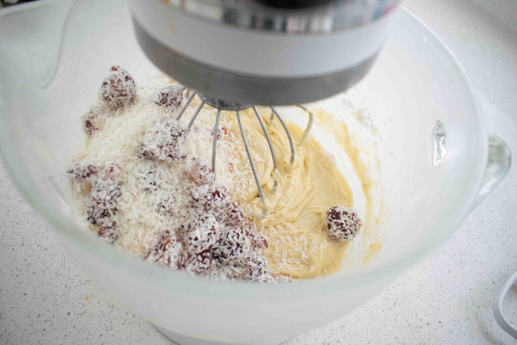 coconut and cherries in cake batter