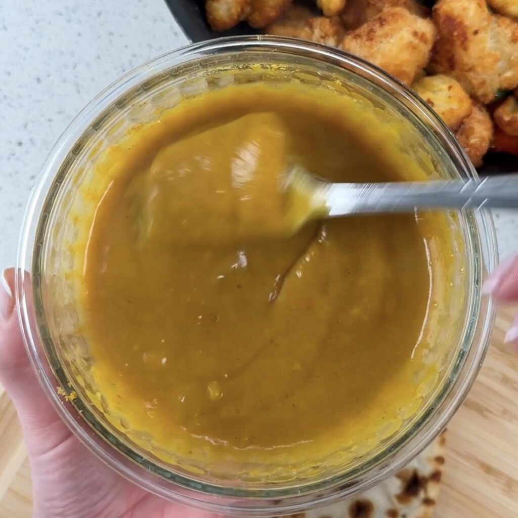 Homemade Mayflower Chinese curry sauce being stirred in a glass bowl