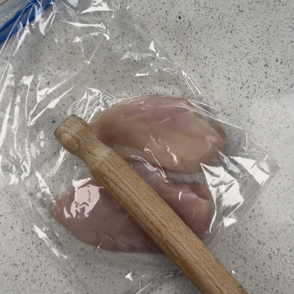 Flatten the chicken breast with a rolling pin