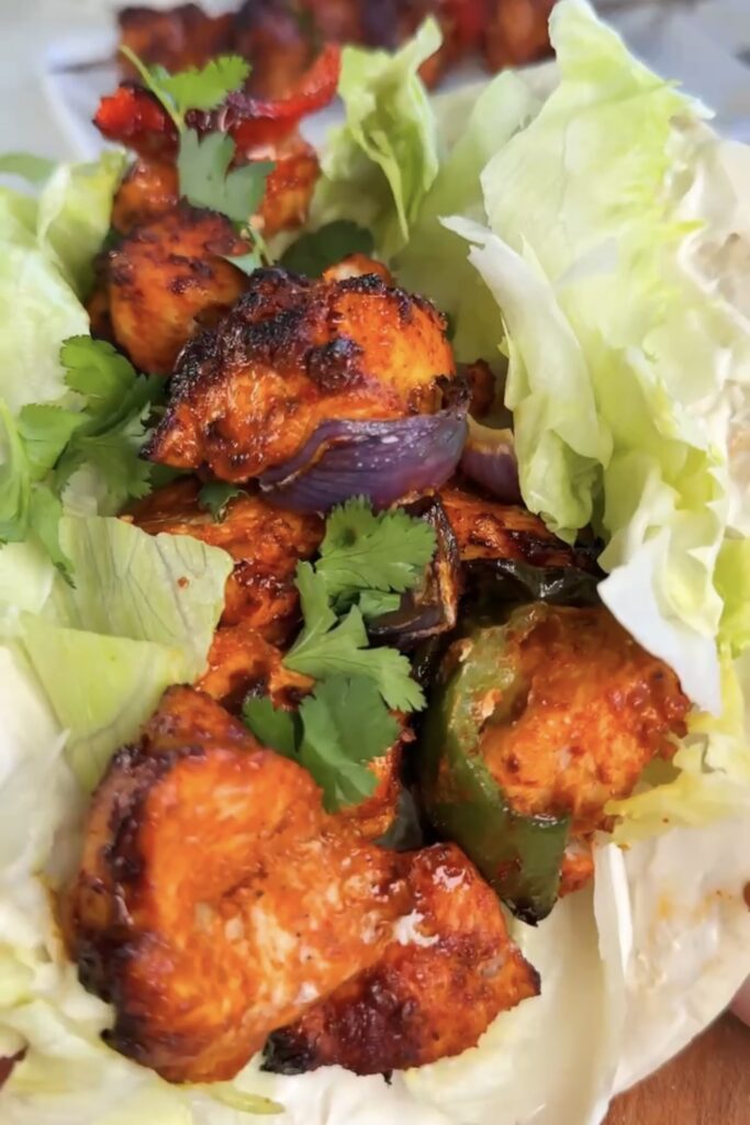 stacked chicken tikka flatbread with lettuce and yogurt