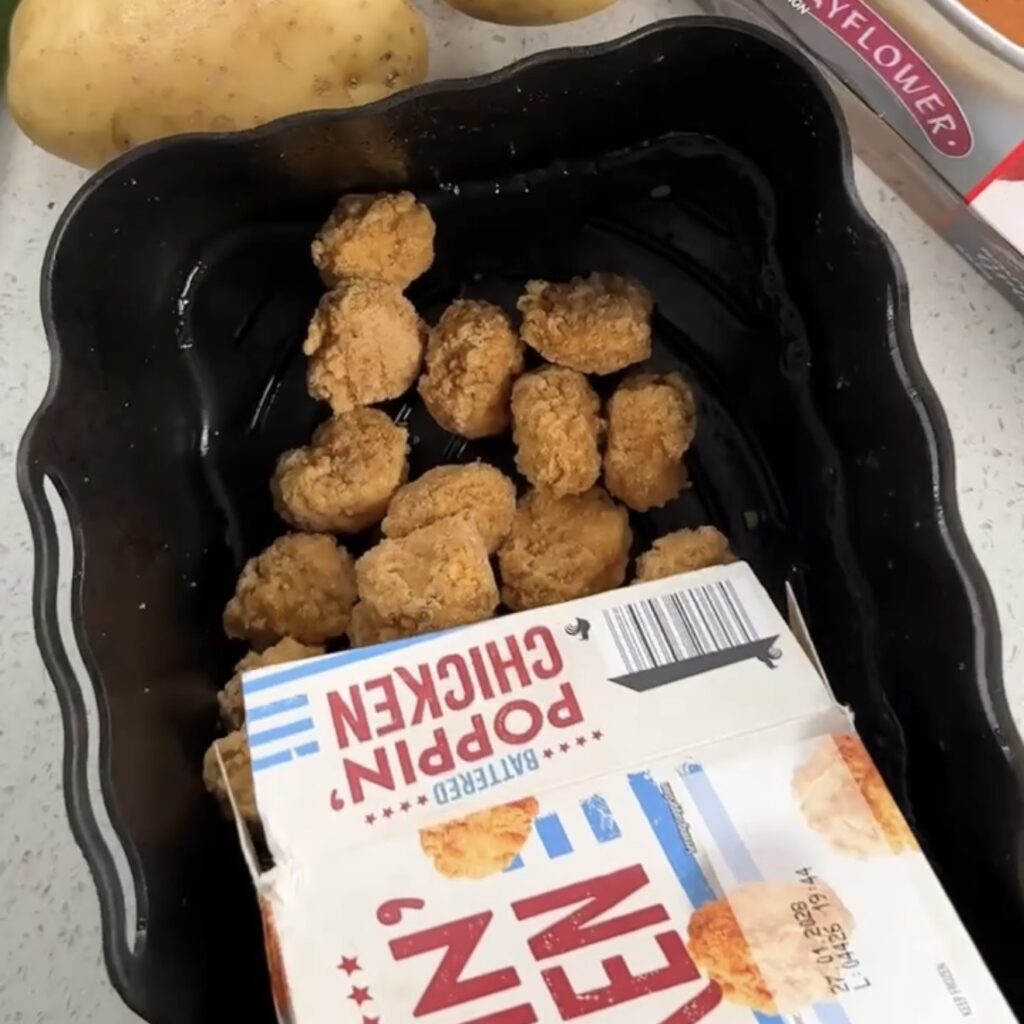 Battered Poppin' Chicken from Aldi being poured into an air fryer basket