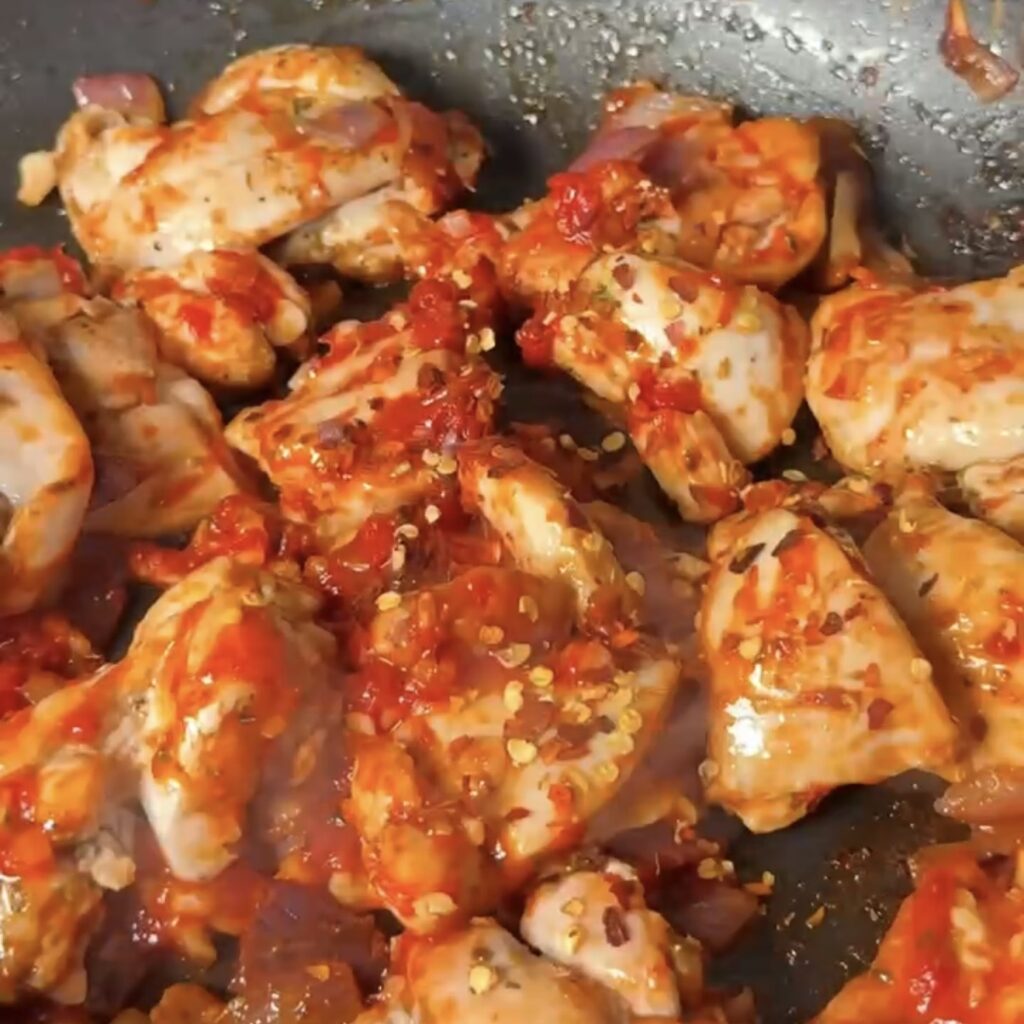 chicken and onion in the pan wit hchilli and tomato